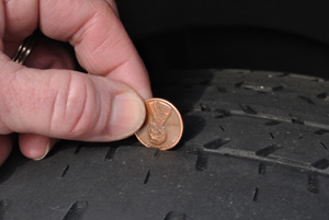 Stick a penny heads down into your tire tread